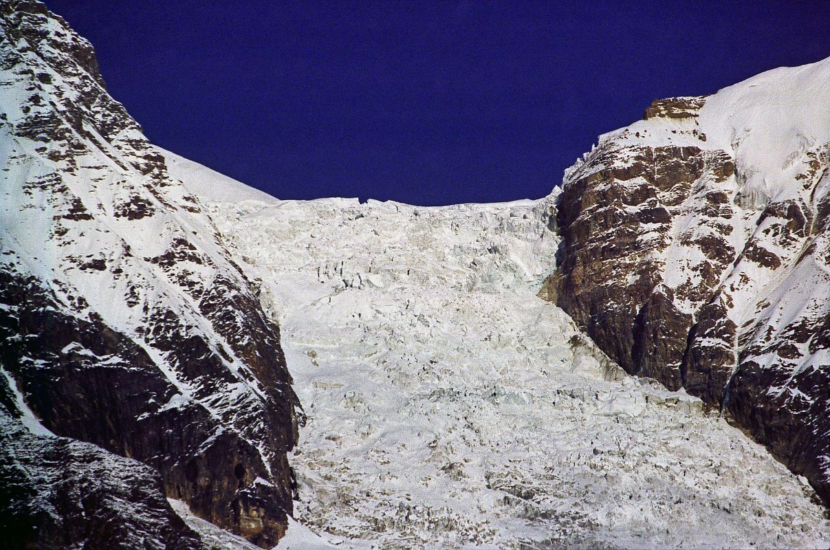 409 Dhaulagiri Icefall Close Up Early Morning From Lete �The East glacier's a great torrent of ice.� R�buffat explained. �Even supposing we did succeed in getting up the glacier,� continued Lachenal, �I don't quite see how we should get on to the north ridge. My own view is that we shouldn't try. It's a regular Walker (The north buttress of the Pointe Walker on the Grandes Jorasses is perhaps the most difficult climb in the Alps) with seracs stuck on!�  ... These mountains are unclimbable! No expedition could ever get through this way [Dhaulagiri Icefall]�� (Maurice Herzog, Annapurna). Here is a close up view of the Dhaulagiri East Glacier from Lete.